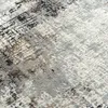 A close-up, textured view of a rug with an abstract pattern. Produktbild-Vorschau