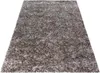 A rectangular rug with a shaggy texture and a mottled beige and brown color pattern, presented on a white background. Produktbild-Vorschau