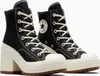 A pair of black Converse Chuck 70 De Luxe Heel high-top platform boots with white laces and soles, shown from a slightly angled front view against a white background. Produktbild-Vorschau