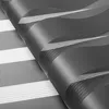 A close-up, angled view of a dark gray roller blind with a striped pattern. Produktbild-Vorschau