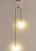 A modern pendant light fixture with two globe-shaped lights hanging from a curved gold-toned arm. Produktbild-Vorschau