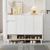 A white shoe cabinet with several compartments and shelves, displaying various shoes and a decorative box. The cabinet is placed in a hallway or entryway, with a rug in front of it. Anteprima dell’immagine prodotto
