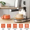 Two cappuccino cups with coffee are placed on a kitchen counter next to a coffee machine. Below the cups are icons indicating product features. Produktbild-Vorschau