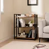 A three-tier bookshelf with books and decorative items in a living room setting. Produktbild-Vorschau