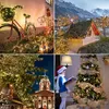 A collage of four festive Christmas scenes, featuring decorated bicycles, houses, and trees with lights. Produktbild-Vorschau