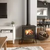 A living room scene with a wood-burning stove, a TV, and a dining area in the background. Anteprima dell’immagine prodotto