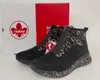 A pair of black Rieker ankle boots with a circular pattern and a zipper is displayed next to its original packaging. Produktbild-Vorschau