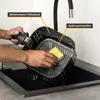 A person is cleaning an air fryer basket in a sink. Produktbild-Vorschau