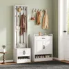 A hallway or entryway with a white coat rack and shoe cabinet set. Produktbild-Vorschau