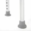 Close-up of the bottom of two legs of a white stool with gray rubber feet, set against a white background. Podgląd zdjęcia produktu