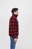 A man is shown from the side wearing a red and black plaid jacket and blue jeans against a white background. Produktbild-Vorschau