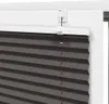 A close-up view of a gray pleated blind attached to a white window frame. Anteprima dell’immagine prodotto