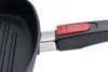 Close-up view of the handle and part of the grill pan of a cooking utensil. Produktbild-Vorschau