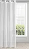 A white sheer curtain hangs in front of a window with a grid pattern. The curtain is partially drawn, covering the left side of the window. The window looks out onto greenery. The floor is made of light-colored wood planks. Produktbild-Vorschau