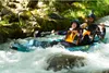 Two people are kayaking down a river. Voir les images du produit