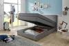 A bedroom scene with an open storage bed, a coat rack, and decorative items on the wall. Produktbild-Vorschau