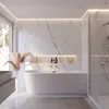 A modern, minimalist bathroom featuring a freestanding bathtub, marble-patterned walls, and a large window. Produktbild-Vorschau