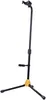 A black and yellow guitar stand is shown against a white background. Produktbild-Vorschau