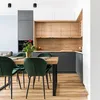 A modern kitchen and dining area with a wooden table and green chairs. Anteprima dell’immagine prodotto