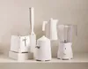 A collection of white kitchen appliances arranged on a shelf. Produktbild-Vorschau