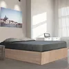 A bedroom scene with a bed, a painting on the wall, and a dresser with a picture frame. Produktbild-Vorschau