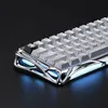 Close-up of a gaming keyboard with a chrome-like metallic base and white keycaps, illuminated by blue LEDs. Produktbild-Vorschau