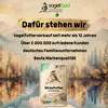 A marketing image for bird food, featuring a bag of bird food in the foreground with a scenic landscape background. Produktbild-Vorschau