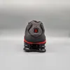 The back view of a black and red Nike Shox TL sneaker against a plain gray background. Produktbild-Vorschau