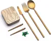 A set of golden cutlery, including a knife, fork, spoon, and chopsticks, along with a small green turtle charm and a rectangular case with the word 'Outlery' embossed on it, are arranged on a white background. Náhľad obrázku produktu