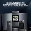 Three body cameras are displayed on a dark, reflective surface with a dark background. The central camera shows a screen displaying a person riding a motorcycle. Produktbild-Vorschau
