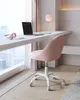 A pink office chair is placed next to a desk with a laptop and headphones. Produktbild-Vorschau