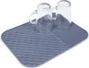 Two clear glasses are placed on a gray drying mat. Produktbild-Vorschau