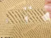 A close-up of text on a newspaper being viewed through a magnifying glass. Náhled obrázku produktu