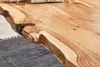Close-up of a wooden table edge with a natural, live edge. Produktbild-Vorschau