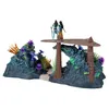 A diorama with two Avatar action figures standing on a platform above a rocky, coral-like structure with colorful flora. Náhled obrázku produktu