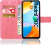 A pink flip case for a Xiaomi Redmi 10C phone, showing credit cards and euro banknotes inserted into the case. Produktbild-Vorschau