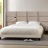 A bedroom scene with a bed and headboard. Produktbild-Vorschau
