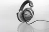 A studio shot of headphones on a reflective surface. Produktbild-Vorschau