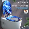 A toilet seat with a dolphin and underwater scene design is shown on a toilet. Produktbild-Vorschau