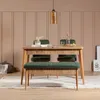 A dining set with a wooden table, green chairs, and a green bench in a room with paneled walls. Produktbild-Vorschau