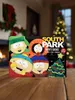 A South Park themed advent calendar with socks, set against a festive Christmas background with a fireplace and Christmas tree. Produktbild-Vorschau