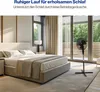 A bedroom with a bed and a fan. Podgląd zdjęcia produktu