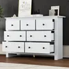 A white wooden dresser with multiple drawers is shown in a room with a dark wall and a rug. Produktbild-Vorschau