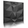 A 3D geometric wall panel with a textured, dark gray surface, shown in a studio setting with a white background and a reflection. Produktbild-Vorschau