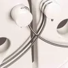 A close-up view of two white cylindrical components with silver wires wrapped around them, attached to a larger white object. Náhľad obrázku produktu