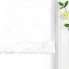 A close-up view of a white roman blind with a subtle damask pattern, partially lowered. Produktbild-Vorschau