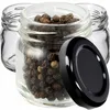 Three small glass jars, one filled with peppercorns, with a black lid in the foreground. Podgląd zdjęcia produktu