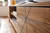 A close-up view of a wooden TV stand with a geometric pattern on its doors. Voir les images du produit