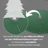 A green Christmas tree skirt with decorative bows and buttons, shown with an arrow indicating how to open and close it. Náhľad obrázku produktu