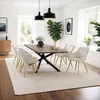 A dining room with a table and chairs set up for a meal. Produktbild-Vorschau